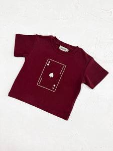 A burgundy t-shirt with "Lucky Ace" print,
